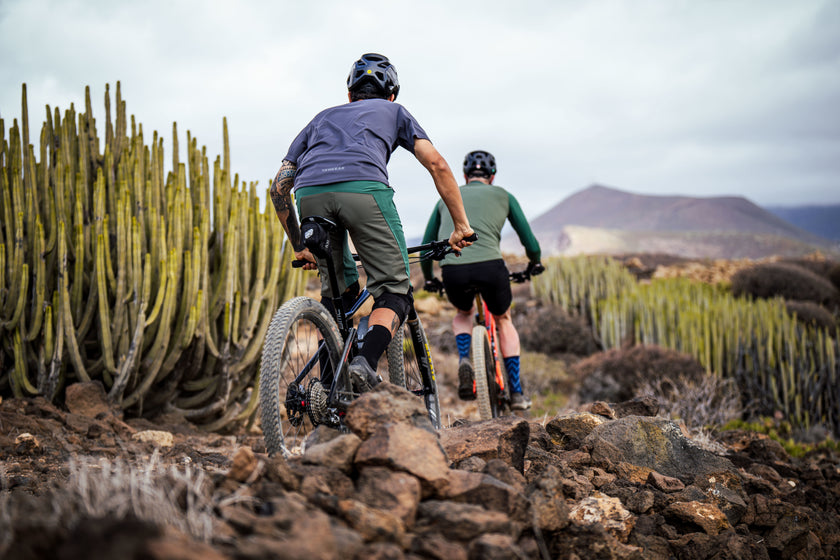 Two mountain bikers riding on a rocky trail