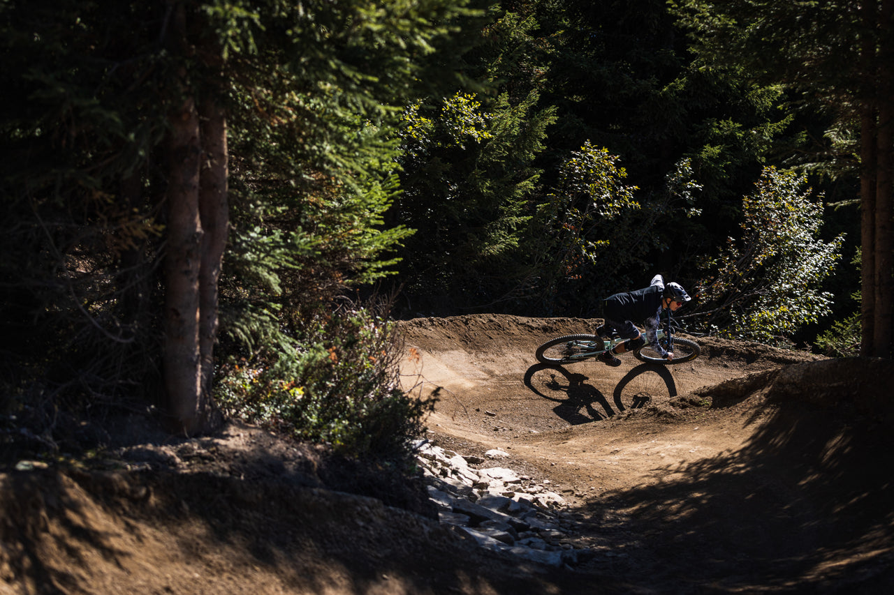 Mountain biker cornering forest trail