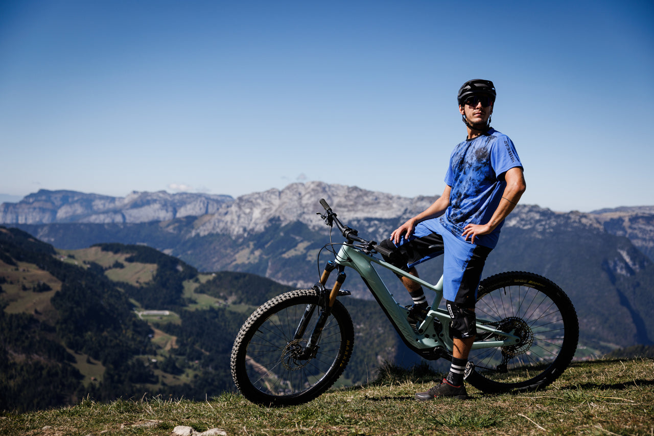 Mountain biker overlooking alpine valley