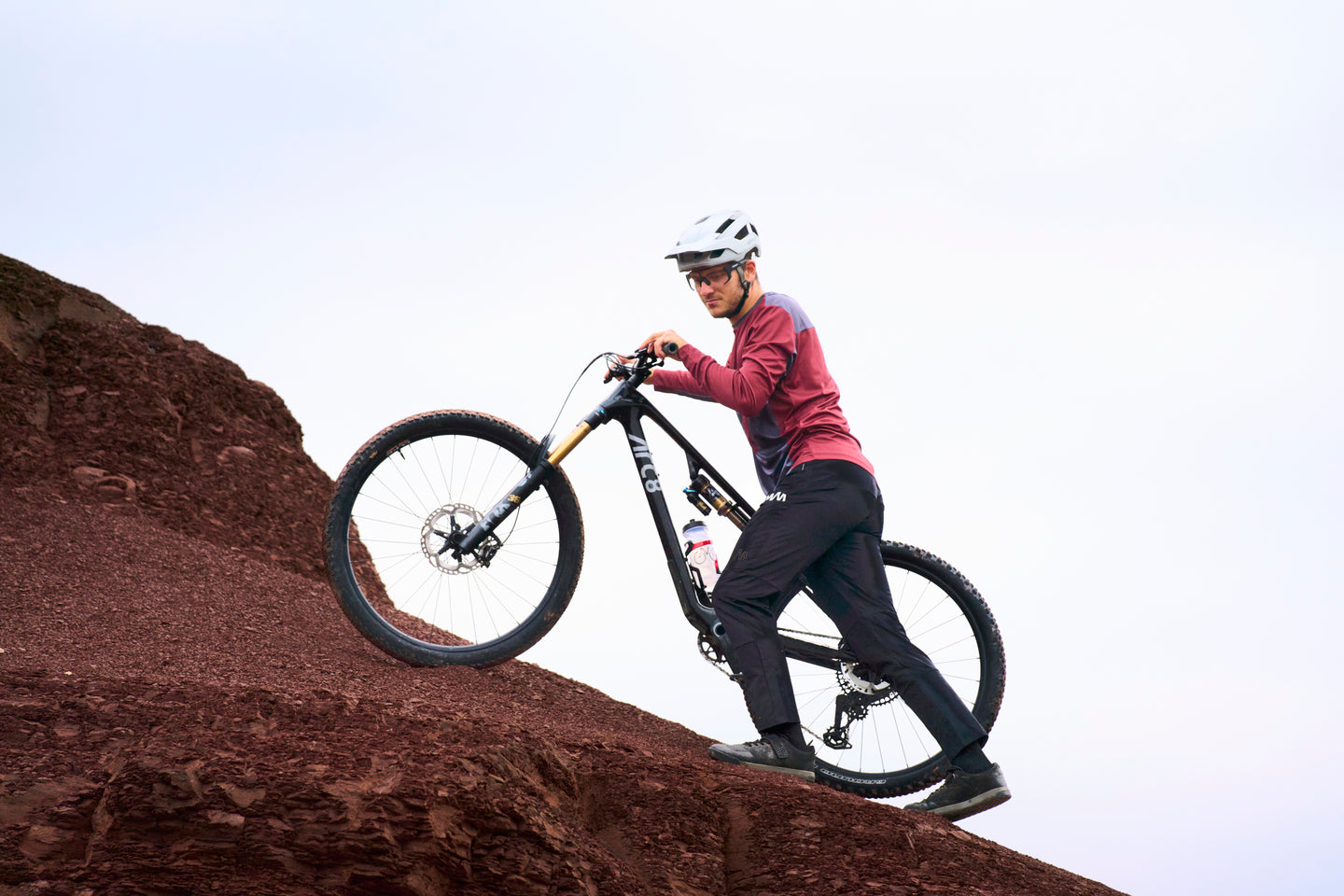 Mountain biker climbing a steep rocky slope